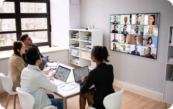 People using a video conference system in an office